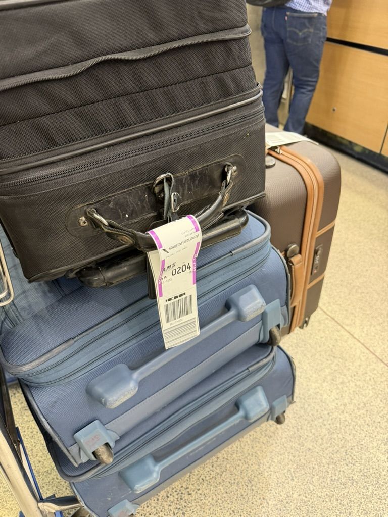 Our luggage, tagged for AMS, at the airport.